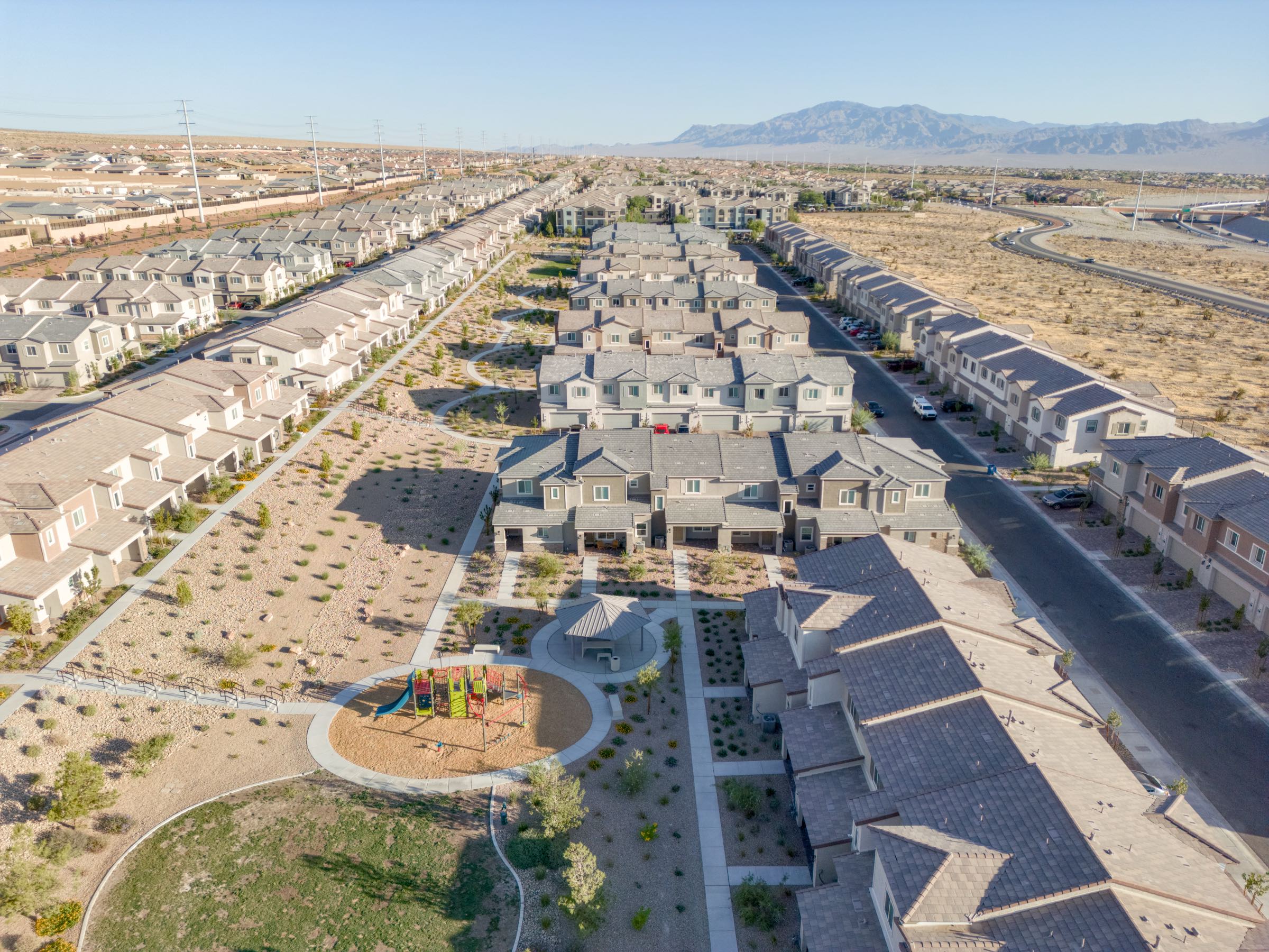 Aerial view over the Lennar townhomes at Centennial Heights, Las Vegas, looking down the rows toward the valley
