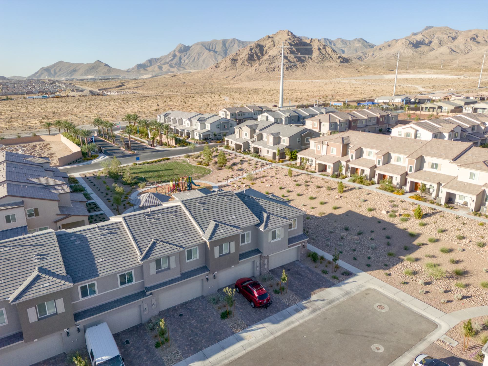 Aerial of Centennial Heights townhomes with the gated entry and desert mountains behind