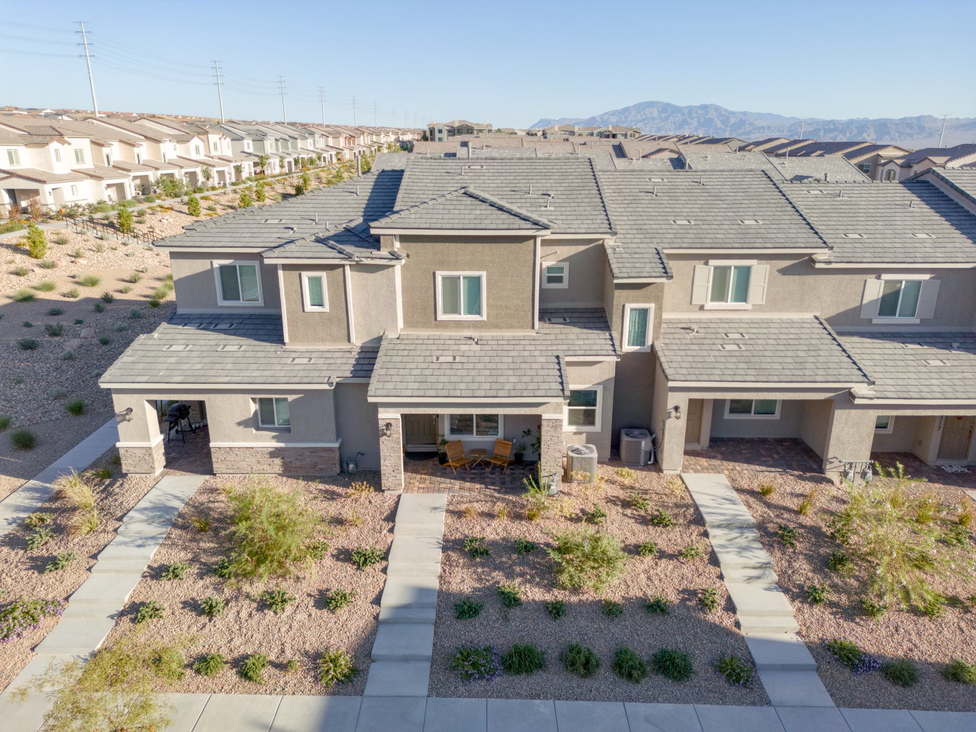 Front elevation of the Lennar townhomes at Centennial Heights, entries, porches, and desert landscaping